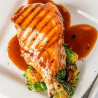 Grilled Loin Pork Chop · Bourbon maple glaze and brussels sprouts.