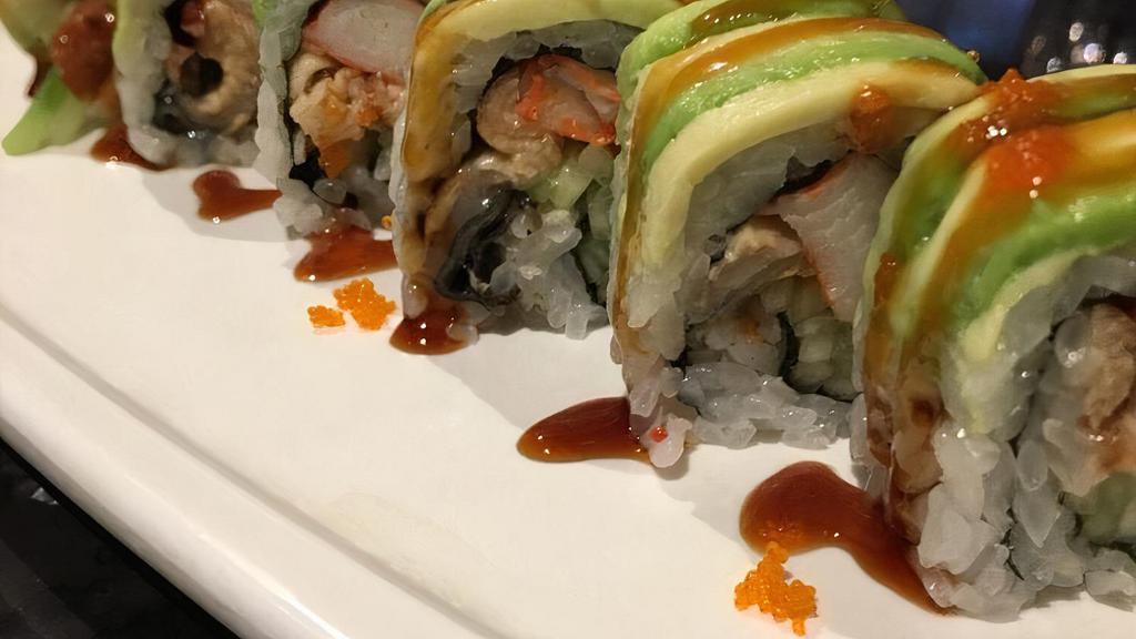 Dragon Roll · Eel, cucumber, snow crab, inside topped avocado, tobiko and eel sauce.
