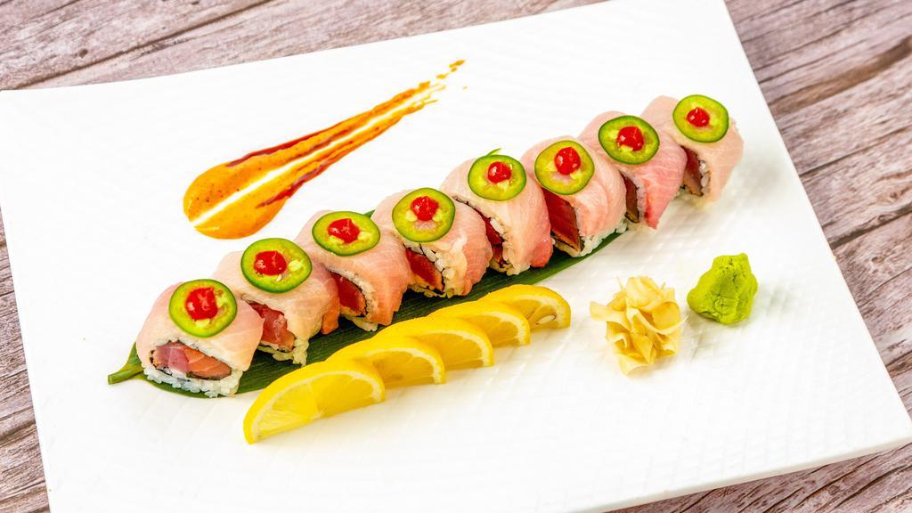 Blue Ocean Roll · Spicy scallop, avocado, crunch inside tobiko, topped with yellowtail, jalapeno and spicy chili sauce.