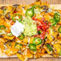 Alcove Nachos · Layered Tortilla Chips, Topped with Black Beans, Melted Jack Cheddar Cheese, Topped with Pic...