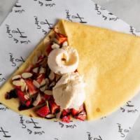 Sundae Crepe · Vanilla ice cream, chocolate syrup, strawberries, whipped cream.