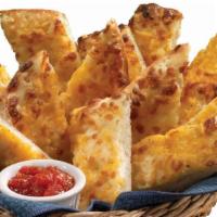 Cheesesticks · 12 pieces. Oven baked with white garlic sauce and topped with Cheddar, Mozzarella, and impor...