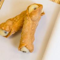Cannoli · Two crispy shells filled with a sweet, creamy filling and chocolate chips.