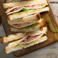Toasted Monte Cristo Panini · Layers of ham and smoked turkey topped with Swiss cheese and cheddar cheese, crisp lettuce a...