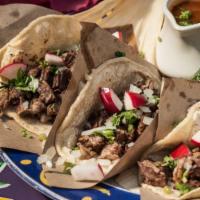 Bistec Tacos · Soft corn tortilla - cilantro and sweet onion. Char-grilled skirt steak.