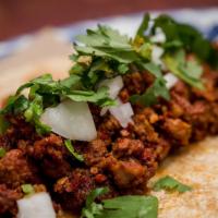 Chorizo Tacos · Soft corn tortilla - cilantro and sweet onion. House-made Chile guajillo sausage.