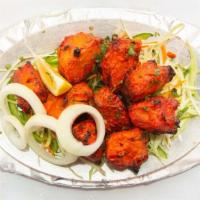 Chicken Tikka · Boneless cubes of chicken breast, marinated in frontier spices, cooked in clay oven, garnish...