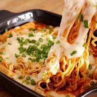 Cheese Ramen Spicy Rice Cake · Rice cakes, fish cakes, ramen, cabbage, scallions, egg, cheese, and fried dumplings with Kor...