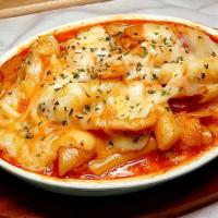 Cheese Spicy Rice Cake · Rice cakes, fish cakes, cabbage, scallions, egg, cheese, and fried dumplings with Korean spi...