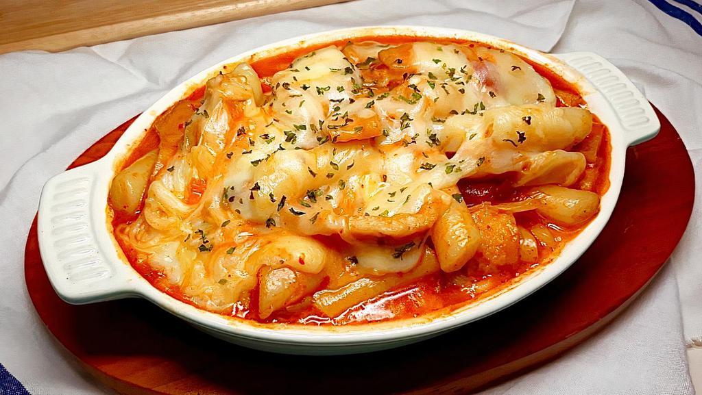 Cheese Spicy Rice Cake · Rice cakes, fish cakes, cabbage, scallions, egg, cheese, and fried dumplings with Korean spicy sauce
