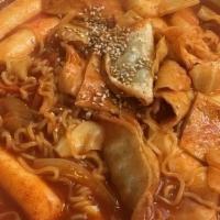 Ramen Spicy Rice Cake · Rice cakes, ramen, fish cakes, cabbage, scallions, egg, and fried dumplings with Korean spic...
