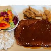 Donkatsu · Pork cutlet, fish cakes, potatoes, salad, and gravy sauce.