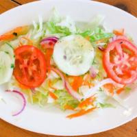 Ensalada De La Casa (House Salad) · Lechuga, zanahoria, tomate, pepino, cebolla y, aderezo. Lettuce, carrots, tomatoes, cucumber...