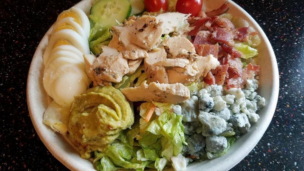 *Chicken Cobb Salad · grilled chicken, salad greens, cucumbers, tomatoes, bacon, crumbled bleu, sliced egg, guacamole, balsamic vinaigrette