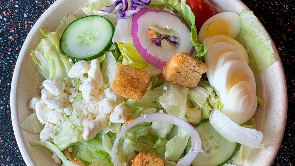 *Garden Salad · fresh crisp salad greens, tomatoes, cucumbers, red onions, feta cheese, sliced egg, croutons and choice of dressing.