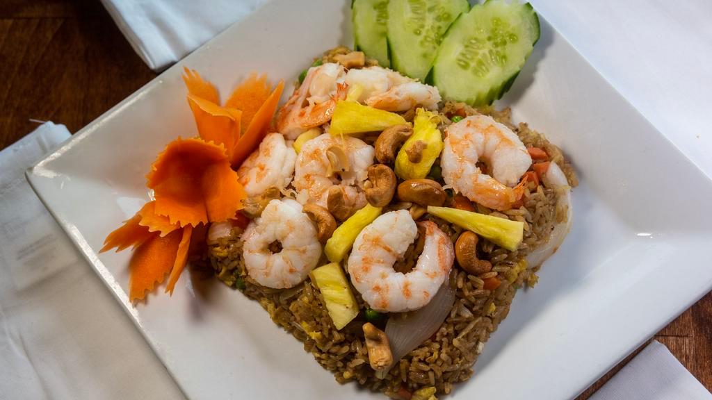 Kow Pad Sub-Pa-Rod (Pineapple Fried Rice) · Fried rice with fresh pineapple, cashew nuts, peas, carrot, onions, and egg.