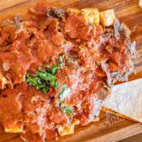 Traditional Iskender Kebab · Served Thinly cut grilled doner kebab over Turkish Bread pieces and yogurt mix, topped with ...