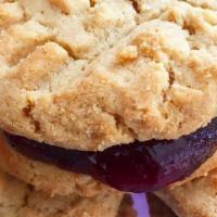 Pb+J Cookie · Two peanut buttah cookies sandwiched between thick strawberry jam.

(contains: nuts)

1 cook...