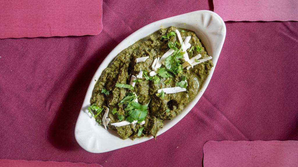 Saag Paneer · Fresh homemade Indian cheese cubes gently cooked with garden spinach, coriander, and mild spices.