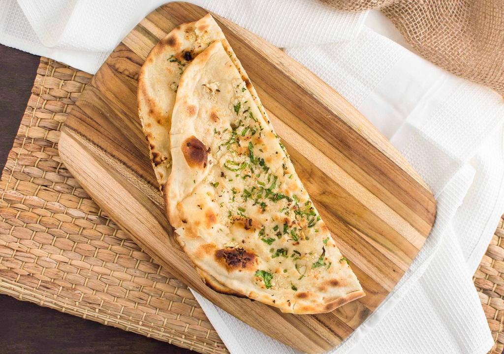 Garlic Naan · A popular aromatic naan topped with fresh chopped garlic and spices.