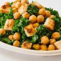 Reg Kale Caesar Salad · Tossed with our Caesar dressing, chickpeas and croutons