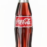 Mexican Coke · Made with cane sugar. This is THE ONE   you have to try, frosty from your fridge, with a bur...