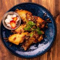 Gai Tod (Thai Chicken Wings) · Deep fried chicken, palm sugar sauce topped with fried garlic and fried shallots.