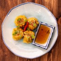 Kanom Jeeb (Thai Dumplings) · Thai style steamed chicken and shrimp dumplings served with sweet soy sauce.