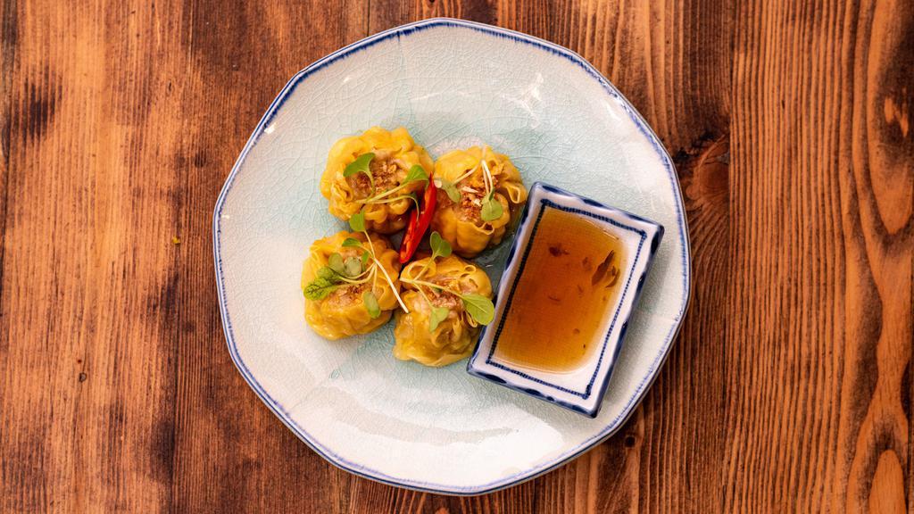 Kanom Jeeb (Thai Dumplings) · Thai style steamed chicken and shrimp dumplings served with sweet soy sauce.