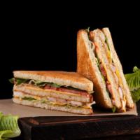 The Turkey Club Panini · Delicious Panini made with Turkey and Bacon, lettuce, tomato, and House dressing.