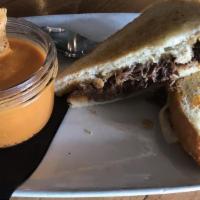 Short Rib Grilled Cheese · Tender braised beef short rib & melted gruyere cheese served on toasted sour dough bread w/ ...