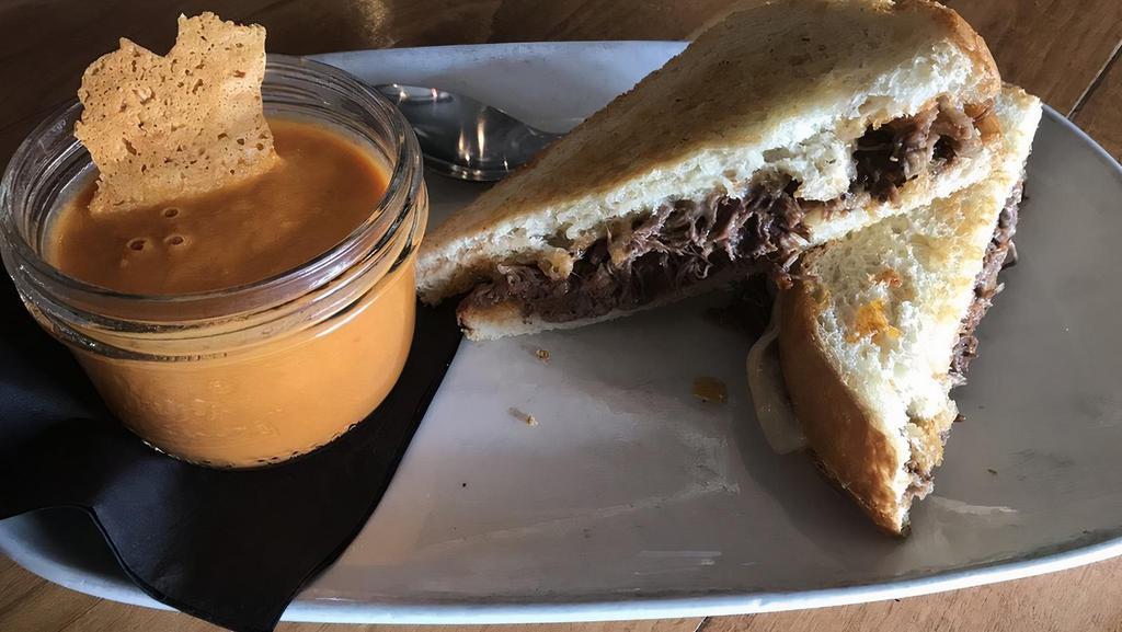 Short Rib Grilled Cheese · Tender braised beef short rib & melted gruyere cheese served on toasted sour dough bread w/ a side of tomato soup dipping sauce