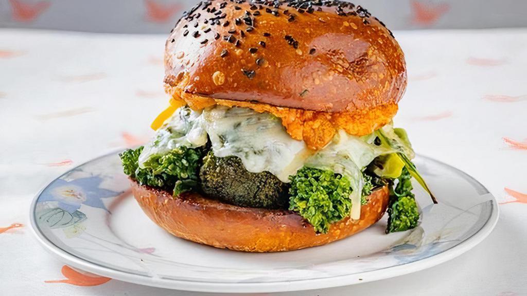 Broccoli Melt · Charred Broccoli + Broccoli Rabe, Romesco Sauce (nut free), pickled peppers and swiss cheese on a Challah Bun
