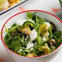Greek-Ish Salad · Arugula, Chopped Broccoli Rabe, Feta, Marinated Cucumbers + Olives with Charred Lemon Vinaig...