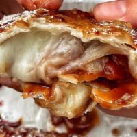 Guava & Cheese Empanada · Fried pastry dough with melted guava and mozzarella cheese.