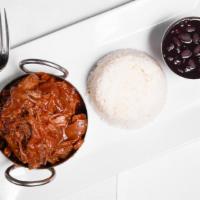 Ropa Vieja · Shredded beef in a creole sauce. Served with black beans and white rice.
