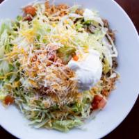 Burrito Bowl  · Layered with beans and rice. Served with your choice of ground beef or shredded chicken. Top...