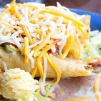 Flautas · Three crispy corn tortillas stuffed with chicken, onions, and cilantro, served with avocado ...
