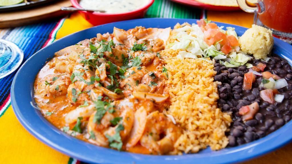 Camarones Al Chipotle · Jumbo shrimp with sautéed mushrooms in spicy creamy chipotle sauce served with rice and beans.
