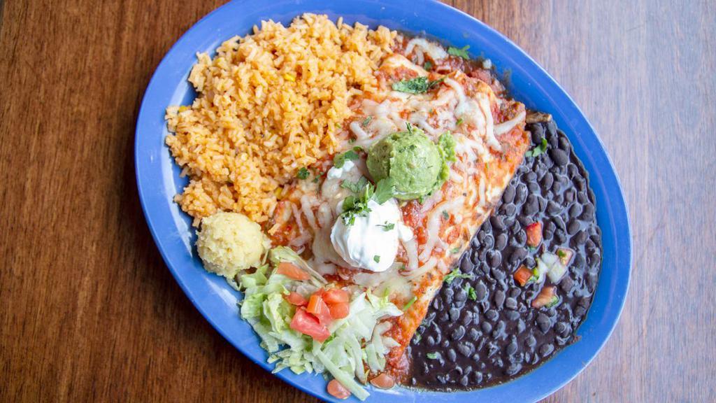Enchiladas Rojas · Steak or chicken ( or both!) with Monterey jack cheese, grilled onions, red & green peppers, wrapped in a flour tortilla. Topped with roasted house salsa & baked. Garnished with sour cream and guacamole. Served with black beans and rice. Lunch portion is one enchilada.