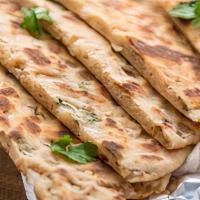 Onion Kulcha · Unleavened bread with minced and spiced onion baked in a clay oven.