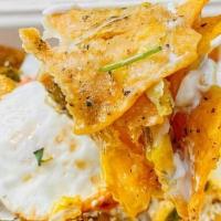 Chilaquiles · (2) fried eggs, tortilla chips, jack cheese, cotija cheese, crema, pico, salsa roja