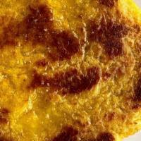 Arepa De Chocolo · sweet yellow cornmeal cake toasted w/ butter