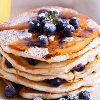 Blueberry Buttermilk Pancakes · 3 perfectly fluffy blueberry pancakes, served with a side of butter and syrup.