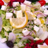 Greek Salad · Tomatoes, cucumbers, onions, peppers, lettuce, olives, feta cheese and chef lemon sauce.