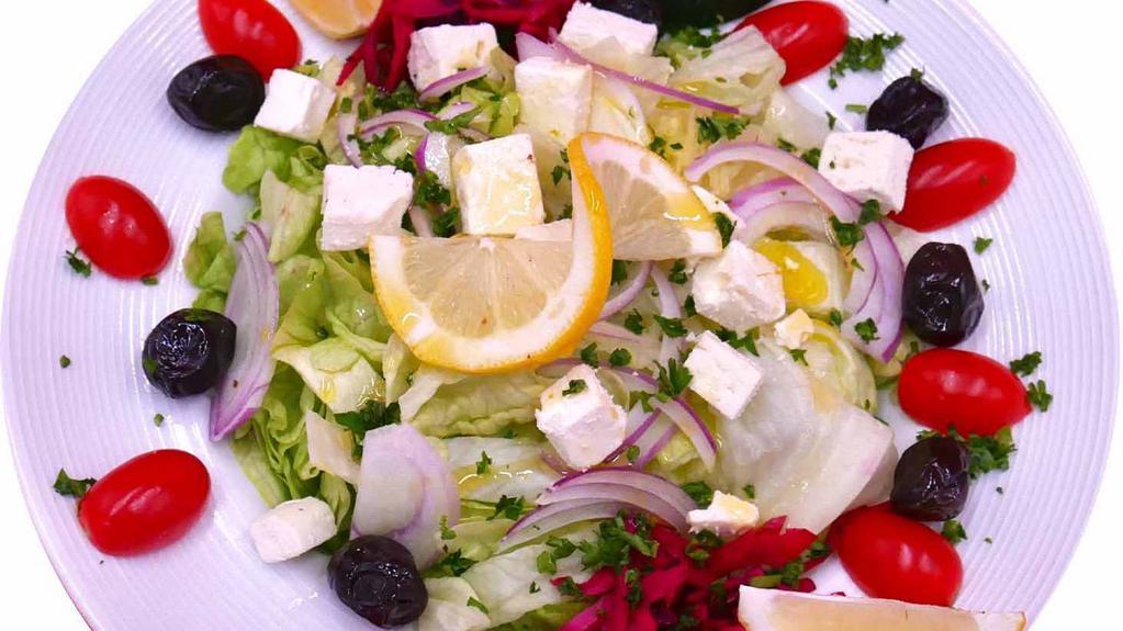 Greek Salad · Tomatoes, cucumbers, onions, peppers, lettuce, olives, feta cheese and chef lemon sauce.
