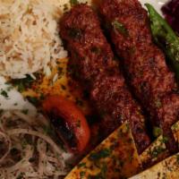 Skewer Kebab (Adana Kebab) · Charcoal grilled chopped lamb with red peppers, grilled tomatoes, pepper with Garlic yogurt ...