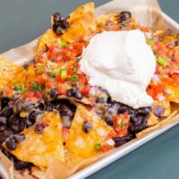 Nachos · Gluten-free. Organic corn tortilla chips, organic black beans, Mexican cheese mix, pico de g...