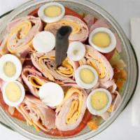 Chef Salad · Fresh garden mix topped with sliced ham, turkey, swiss and American cheese, real bacon bits,...