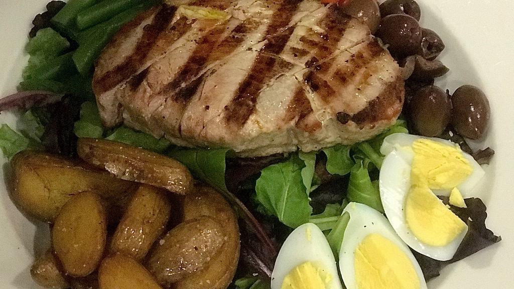 Nicoise Salad · Mixed greens, grape tomatoes, green beans, olives, boiled egg, roasted potatoes, tuna steak with balsamic vinegar dressing.
